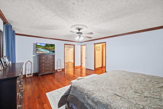 bedroom featuring baseboards, a ceiling fan, wood finished floors, crown molding, and a textured ceiling