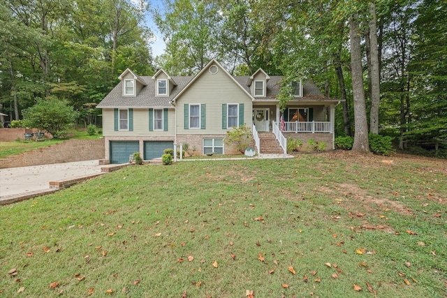 view of front of house with a front yard, covered porch, driveway, and an attached garage