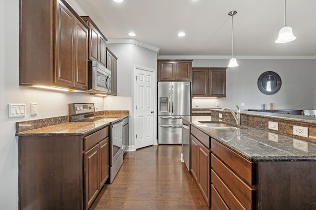 kitchen with a sink, dark brown cabinets, ornamental molding, appliances with stainless steel finishes, and dark wood finished floors