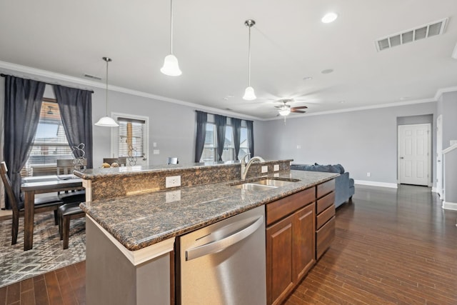 kitchen featuring a kitchen island with sink, a sink, visible vents, stainless steel dishwasher, and brown cabinets