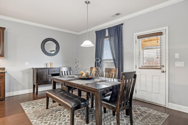 dining area featuring ornamental molding, visible vents, and dark wood finished floors