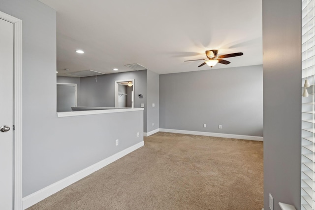 carpeted spare room featuring attic access, recessed lighting, baseboards, and a ceiling fan