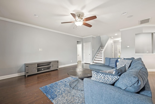 living area with wood finished floors, visible vents, baseboards, and stairs