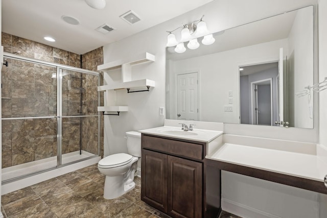 bathroom featuring visible vents, vanity, a shower stall, and toilet