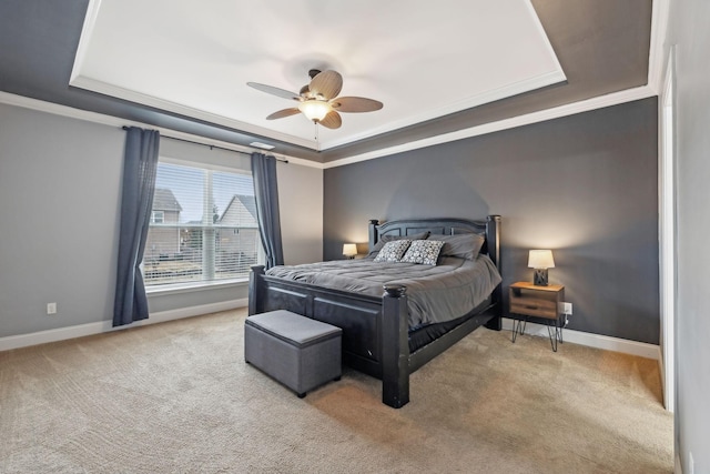 bedroom featuring ornamental molding, carpet flooring, a raised ceiling, and baseboards