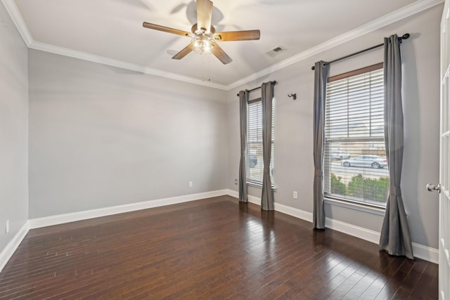 empty room with wood-type flooring, visible vents, ornamental molding, ceiling fan, and baseboards