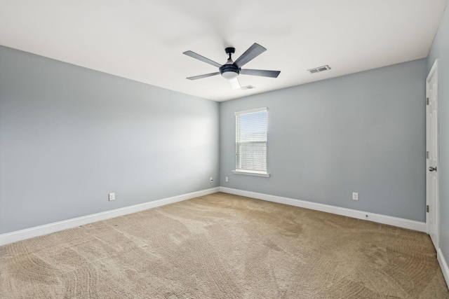 unfurnished room featuring visible vents, carpet floors, a ceiling fan, and baseboards