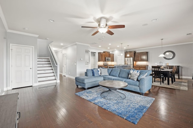 living area with dark wood-style floors, baseboards, stairway, and crown molding