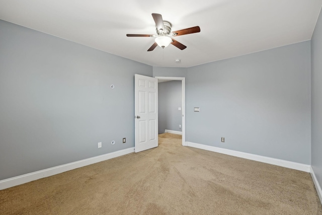 unfurnished room featuring light carpet, ceiling fan, and baseboards