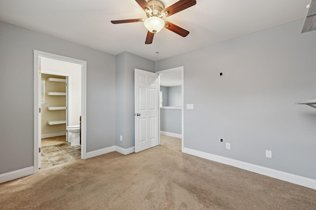 unfurnished bedroom with carpet floors, connected bathroom, a ceiling fan, and baseboards