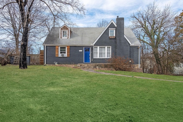 cape cod-style house featuring brick siding, a chimney, and a front lawn