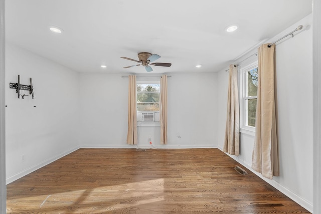 unfurnished room with recessed lighting, visible vents, wood finished floors, cooling unit, and baseboards