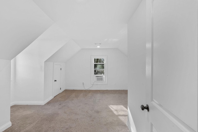 additional living space with carpet, baseboards, and vaulted ceiling