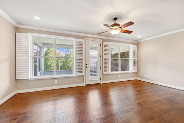 empty room with ceiling fan, crown molding, baseboards, and wood finished floors