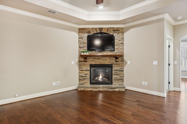 unfurnished living room with ornamental molding, visible vents, and wood finished floors