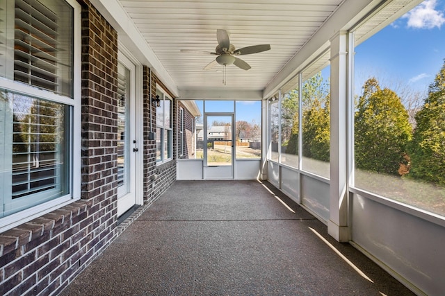 unfurnished sunroom with a ceiling fan