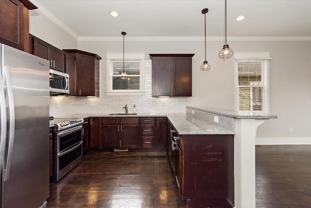 kitchen featuring stainless steel appliances, dark wood-type flooring, ornamental molding, and a peninsula