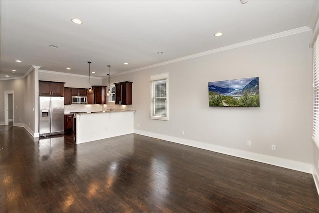 unfurnished living room featuring dark wood-style floors, ornamental molding, recessed lighting, and baseboards