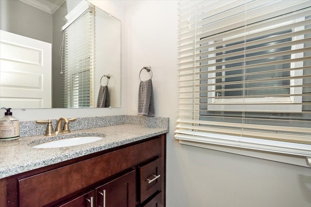 bathroom featuring ornamental molding and vanity