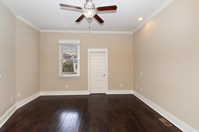 spare room featuring baseboards, wood finished floors, and ornamental molding