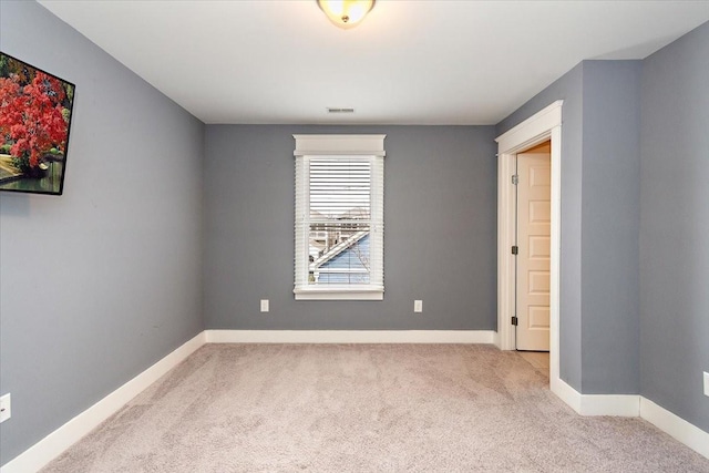 unfurnished bedroom with carpet floors, visible vents, and baseboards