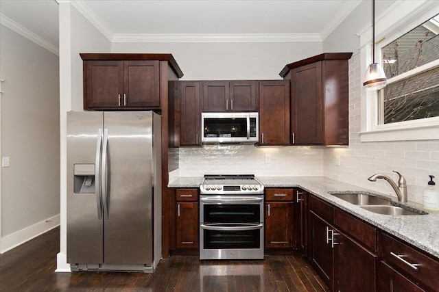 kitchen featuring stainless steel appliances, dark wood-type flooring, a sink, and light stone counters