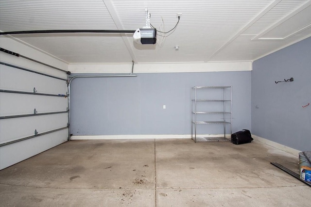 garage featuring a garage door opener and baseboards