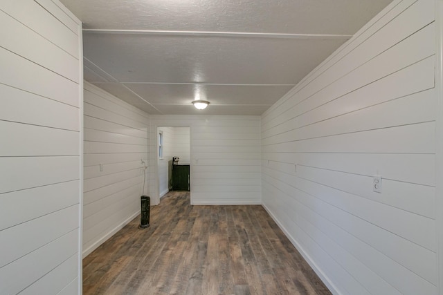 unfurnished room with dark wood-type flooring