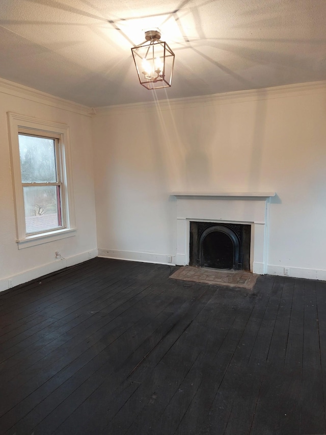 unfurnished living room with hardwood / wood-style flooring, a fireplace with flush hearth, baseboards, and crown molding