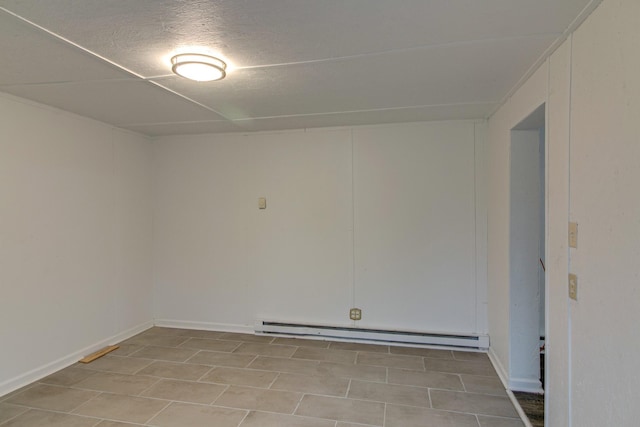 spare room featuring a textured ceiling and baseboard heating