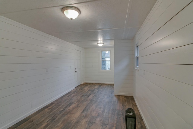 unfurnished room with dark wood finished floors and baseboards