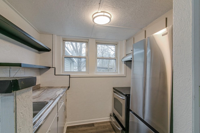 kitchen with appliances with stainless steel finishes, dark wood-type flooring, a textured ceiling, under cabinet range hood, and open shelves