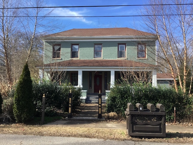 view of front facade featuring a porch and a shingled roof