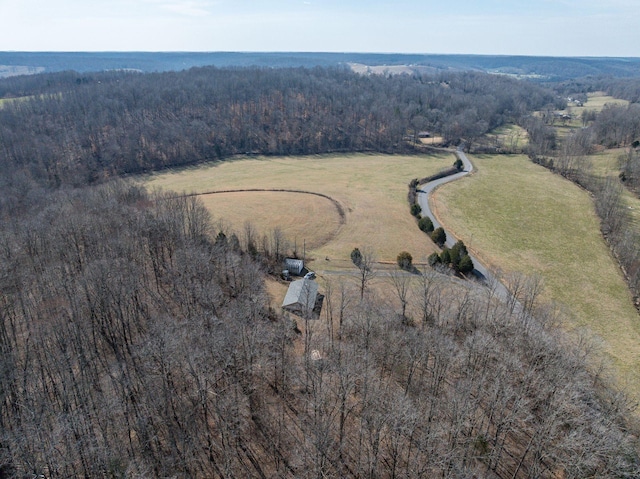 birds eye view of property with a rural view and a wooded view