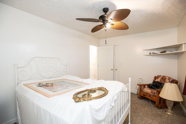 carpeted bedroom with a ceiling fan and a textured ceiling