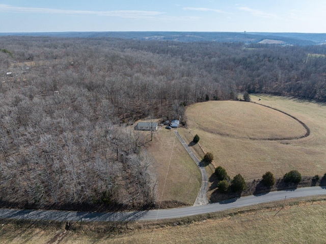 birds eye view of property with a forest view