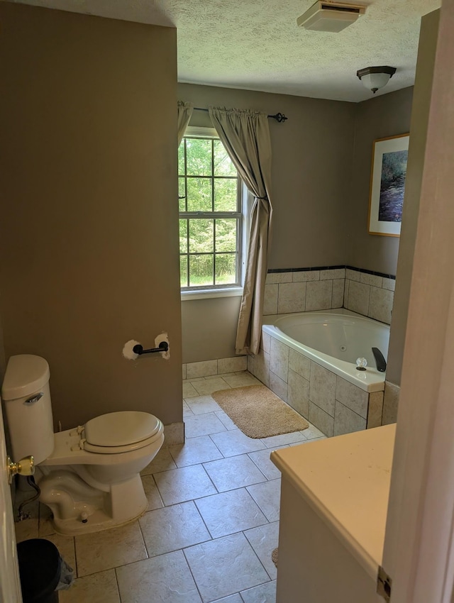 4460 Bold Springs Rd, Mc Ewen, TN 37101 - bathroom featuring tiled tub, toilet, a textured ceiling, and tile patterned flooring