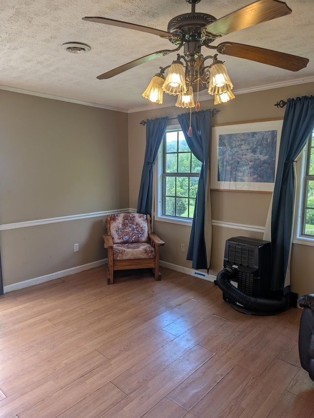 4460 Bold Springs Rd, Mc Ewen, TN 37101 - living area featuring a textured ceiling, ceiling fan, ornamental molding, plenty of natural light, and light wood-style flooring