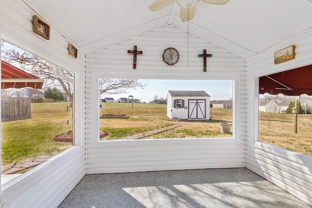 unfurnished sunroom with lofted ceiling and ceiling fan