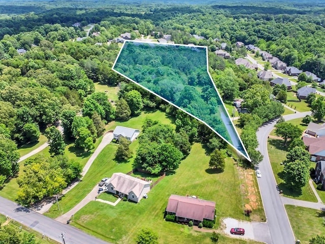 birds eye view of property with a view of trees