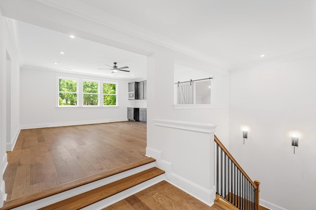 stairs with baseboards, ornamental molding, wood finished floors, and recessed lighting