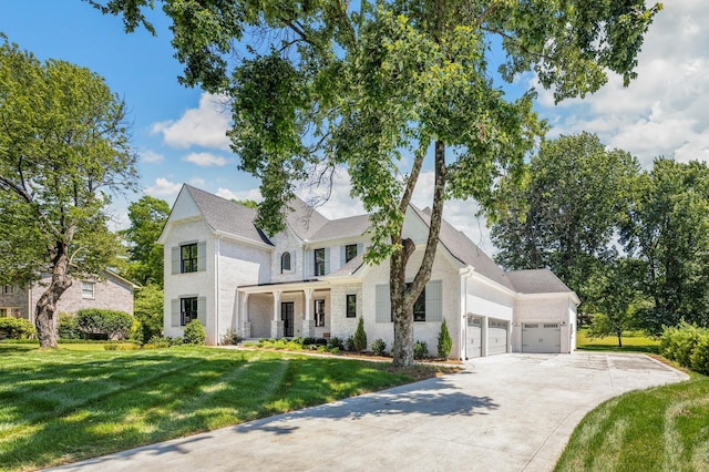 view of front of property with an attached garage, concrete driveway, and a front yard