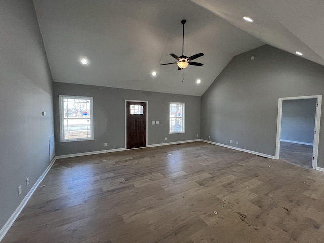 unfurnished living room featuring recessed lighting, a ceiling fan, wood finished floors, high vaulted ceiling, and baseboards