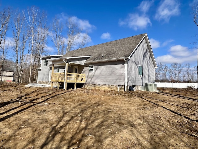 rear view of property with central air condition unit and a deck