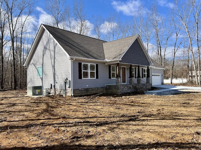 view of front of house featuring a garage, central AC, and a shingled roof