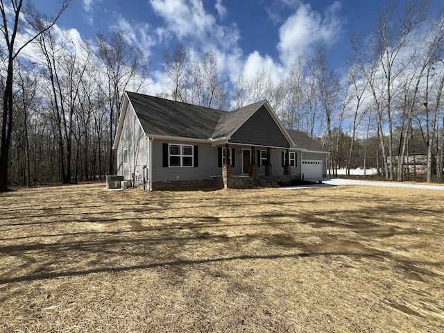 view of home's exterior with driveway, a garage, and central AC