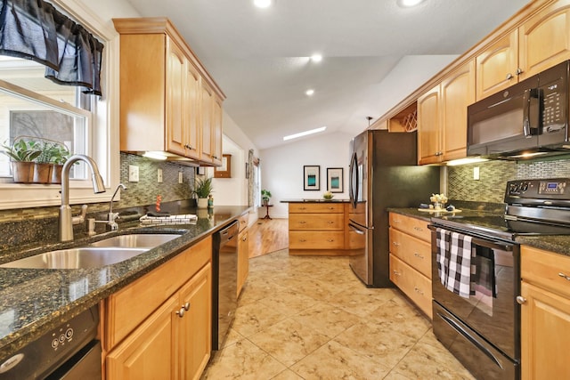 kitchen with lofted ceiling, backsplash, a sink, dark stone counters, and black appliances