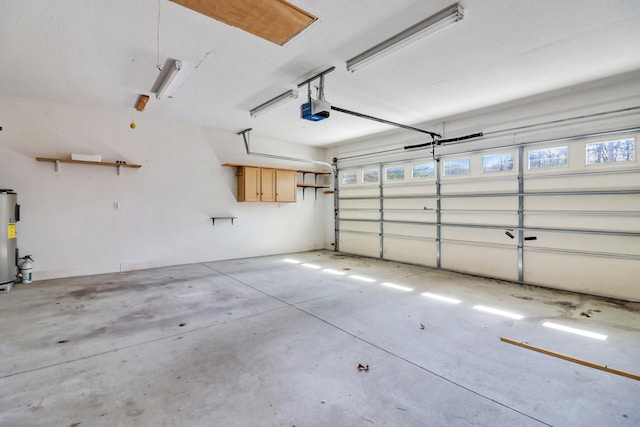 garage featuring electric water heater and a garage door opener