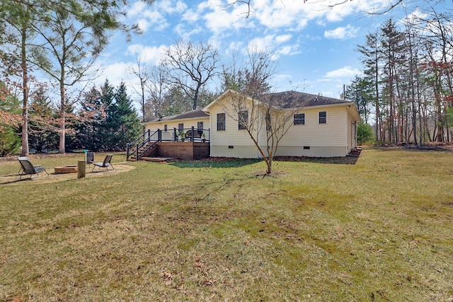 view of home's exterior featuring a fire pit, a lawn, stairway, crawl space, and a wooden deck