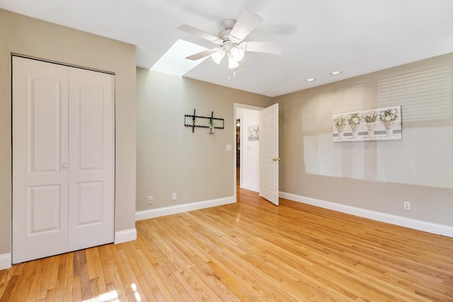 interior space with light wood-type flooring, ceiling fan, and baseboards